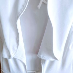 Brand new, white, jumpsuit with back out.